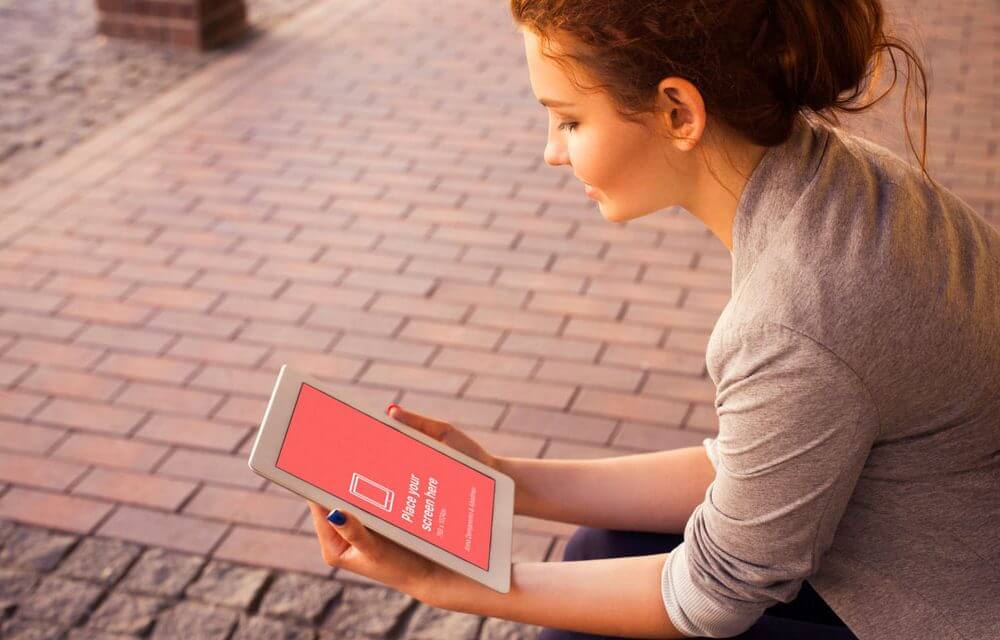 Young Woman looking at iPad Mockup