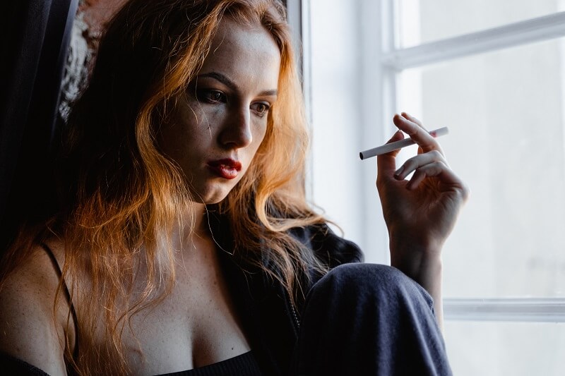 Close-up Photo of Distressed Woman smoking Cigarette