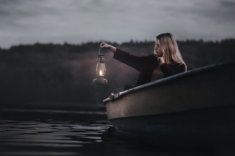 Woman On A Boat Holding Gas Lantern