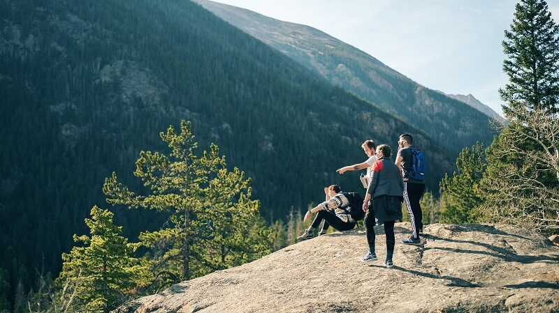 People standing on rocky hill during daytime